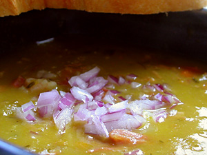 Ham and Split Pea Soup with red onion garnish and bread